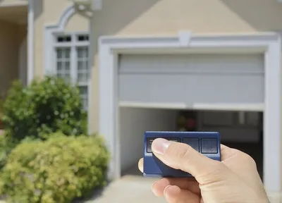 Close up of a technician using a garage door remote control